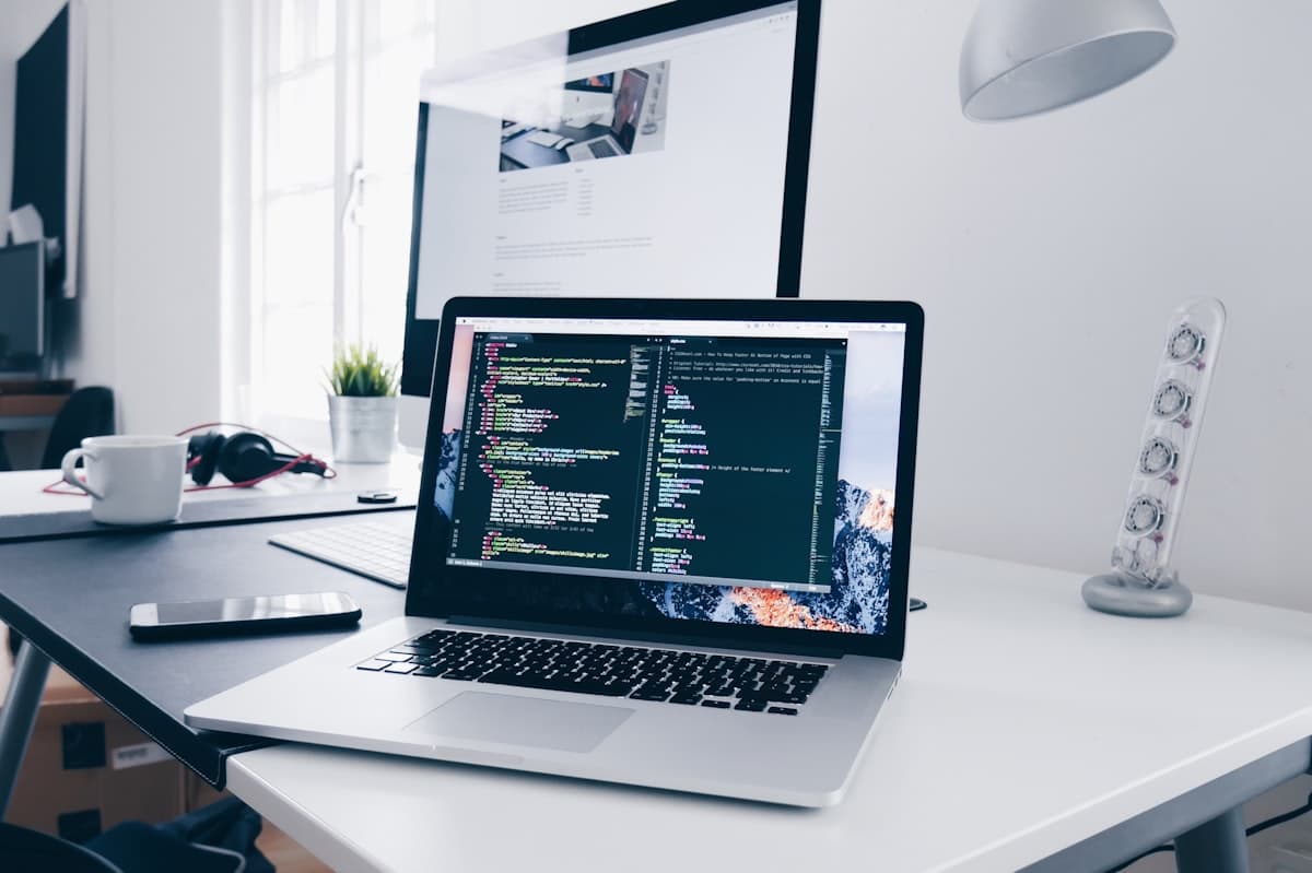 A laptop open on an editor late in a build