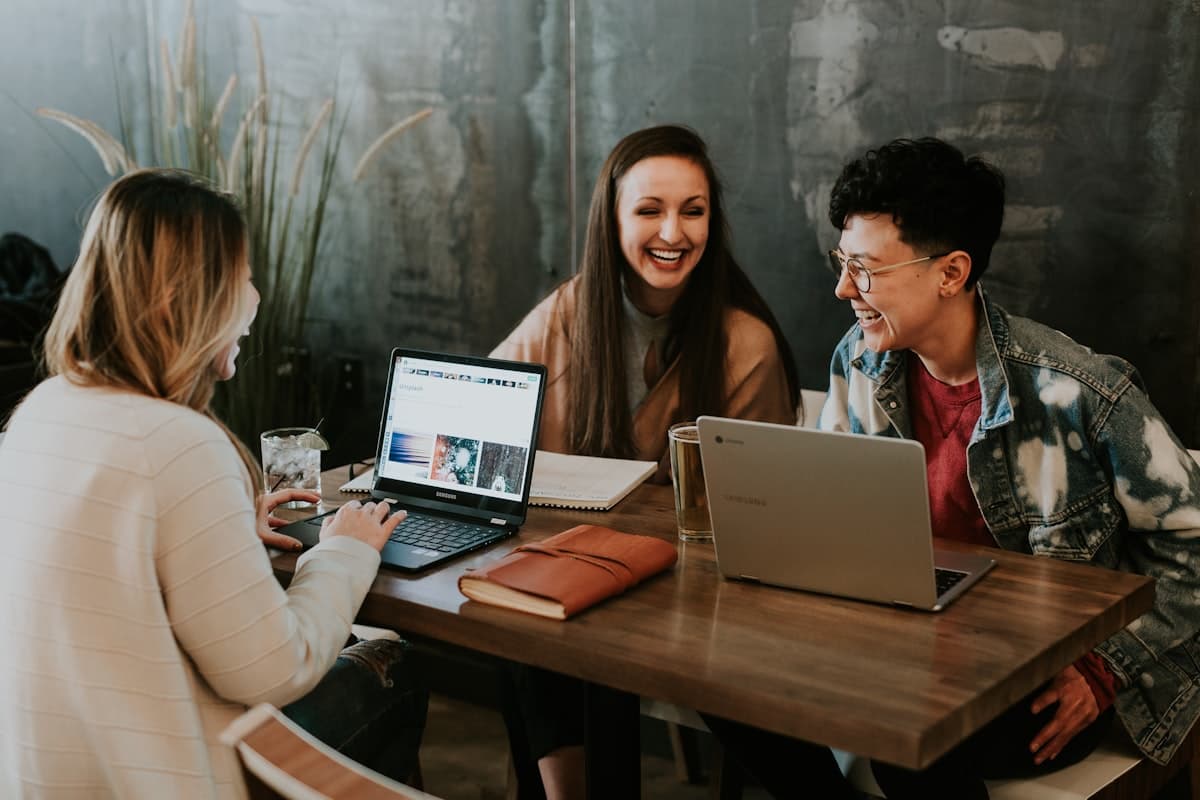 Designers and engineers reviewing work on a laptop together